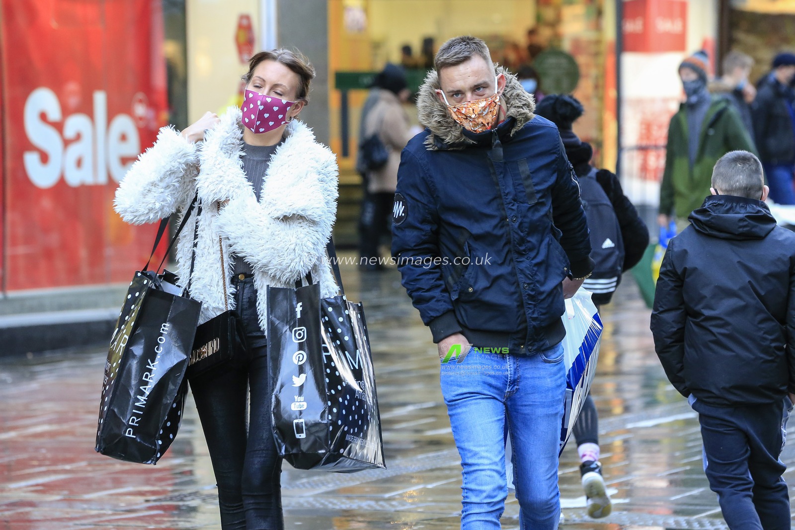 A wet Northumberland Street in Newcastle upon Tyne on Christmas Eve as shoppers venture out in the sleet