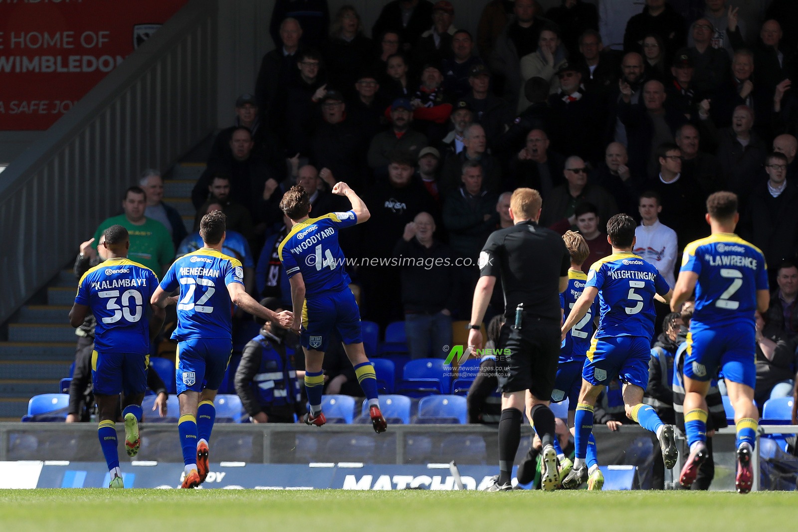 GOAL: Alex Woodyard #4 of AFC Wimbledon celebrates scoring.