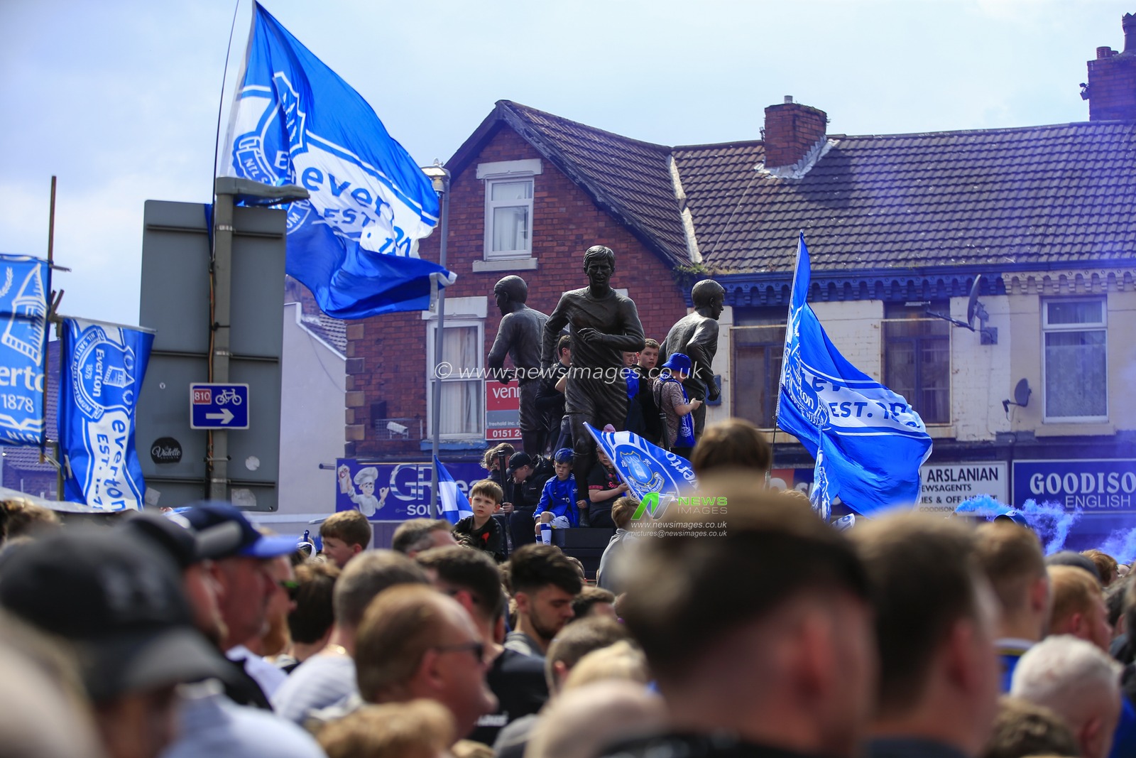 Everton fans await the arrival of the team bus