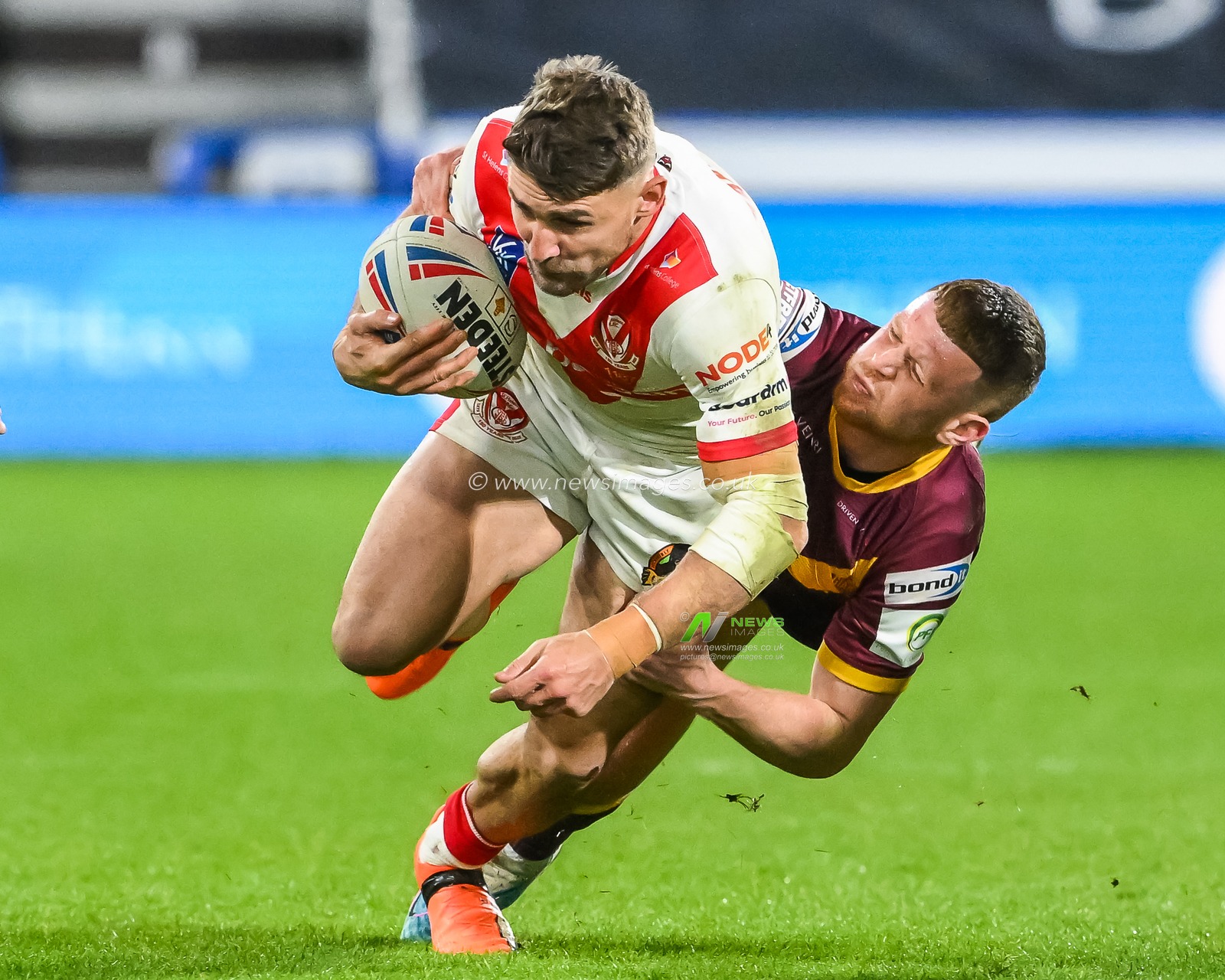 Tommy Makinson #2 of St Helens is tackled by Olly Russell #23 of Huddersfield Giants during the Betfred Super League Round 6 match Huddersfield Giants vs St Helens at John Smith's Stadium, Huddersfield, United Kingdom, 23rd March 2023

(Photo by Craig Thomas/News Images)