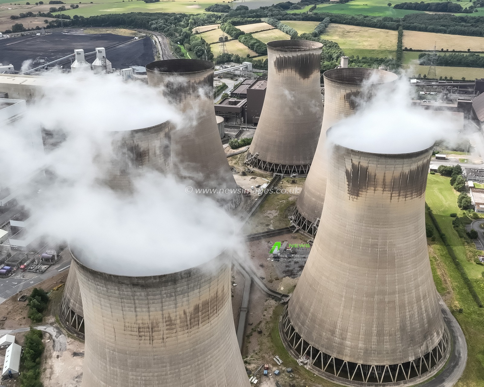 An aerial view of Drax Power Station. Drax Power Station is responsible for generating 11% of the renewable energy in the UK. It offers a secure, dependable, and adaptable source of renewable energy, which helps to complement more variable sources such as wind and solar power. Located near Selby in North Yorkshire, Drax is the largest single renewable energy site in the country, producing approximately 14 terawatt-hours (TWh) of electricityâ€”enough to supply power to around five million homes. 

By utilising biomass pellets, Drax significantly lowers its carbon emissions by 80% when compared to traditional coal. The facility comprises four biomass-fired units, each with a capacity of 645MW, contributing to its total output of about 14 terawatt-hours (TWh) at Drax Power Station, Selby, United Kingdom, 16th August 2024

(Photo by Mark Cosgrove/News Images)