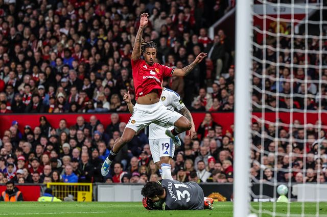 Leny Yoro of Manchester United jumps over Manchester United goalkeeper Senne Lammens as he collects the ball during the Premier League match Manchester United vs Leeds United at Old Trafford, Manchester, United Kingdom on 13 April 2026

(Photo by Mark Cosgrove/News Images)