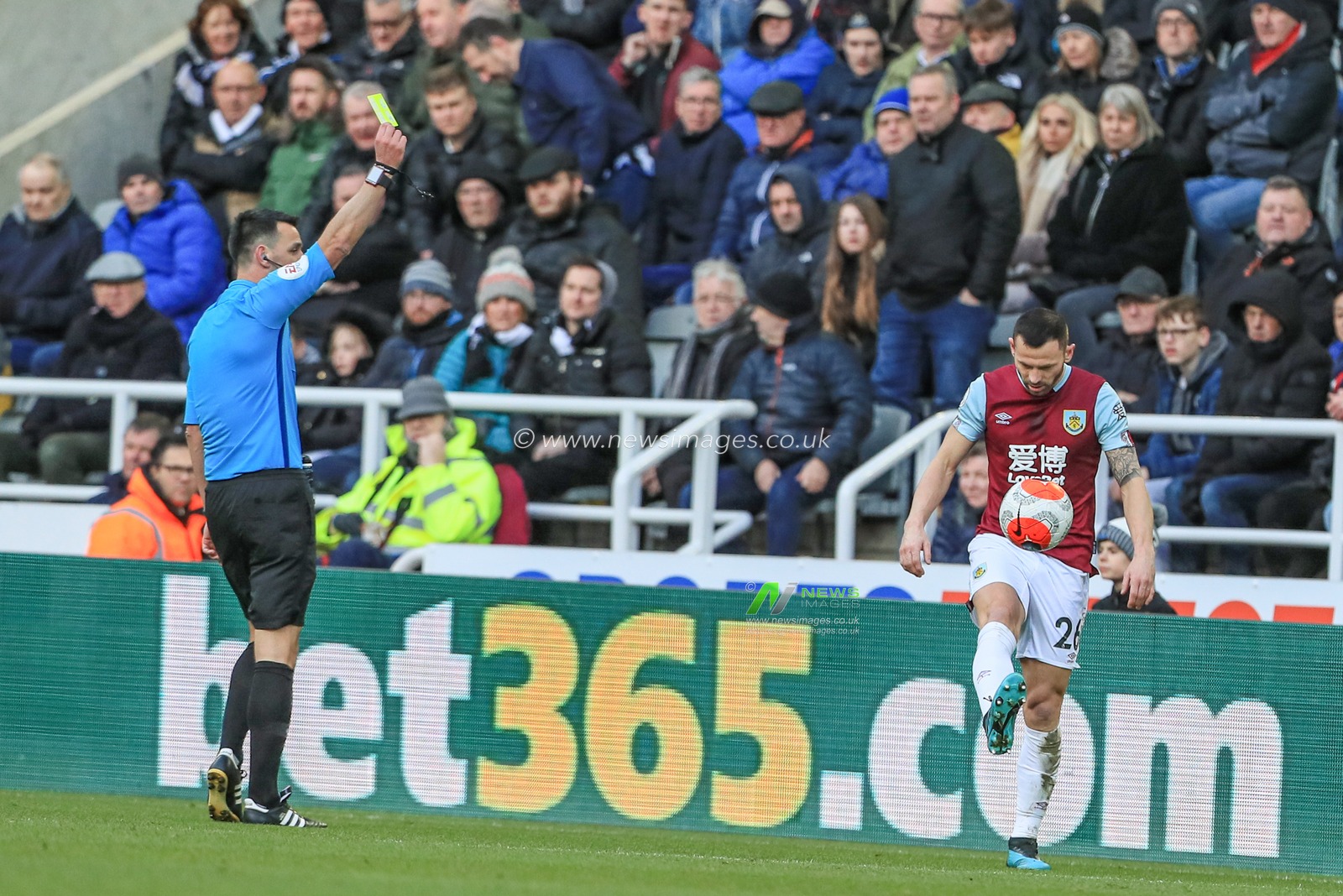 29th February 2020, St. James's Park, Newcastle, England; Premier League, Newcastle United v Burnley : referee Andrew Madley gives Phil Bardsley (26) of Burnley a yellow card