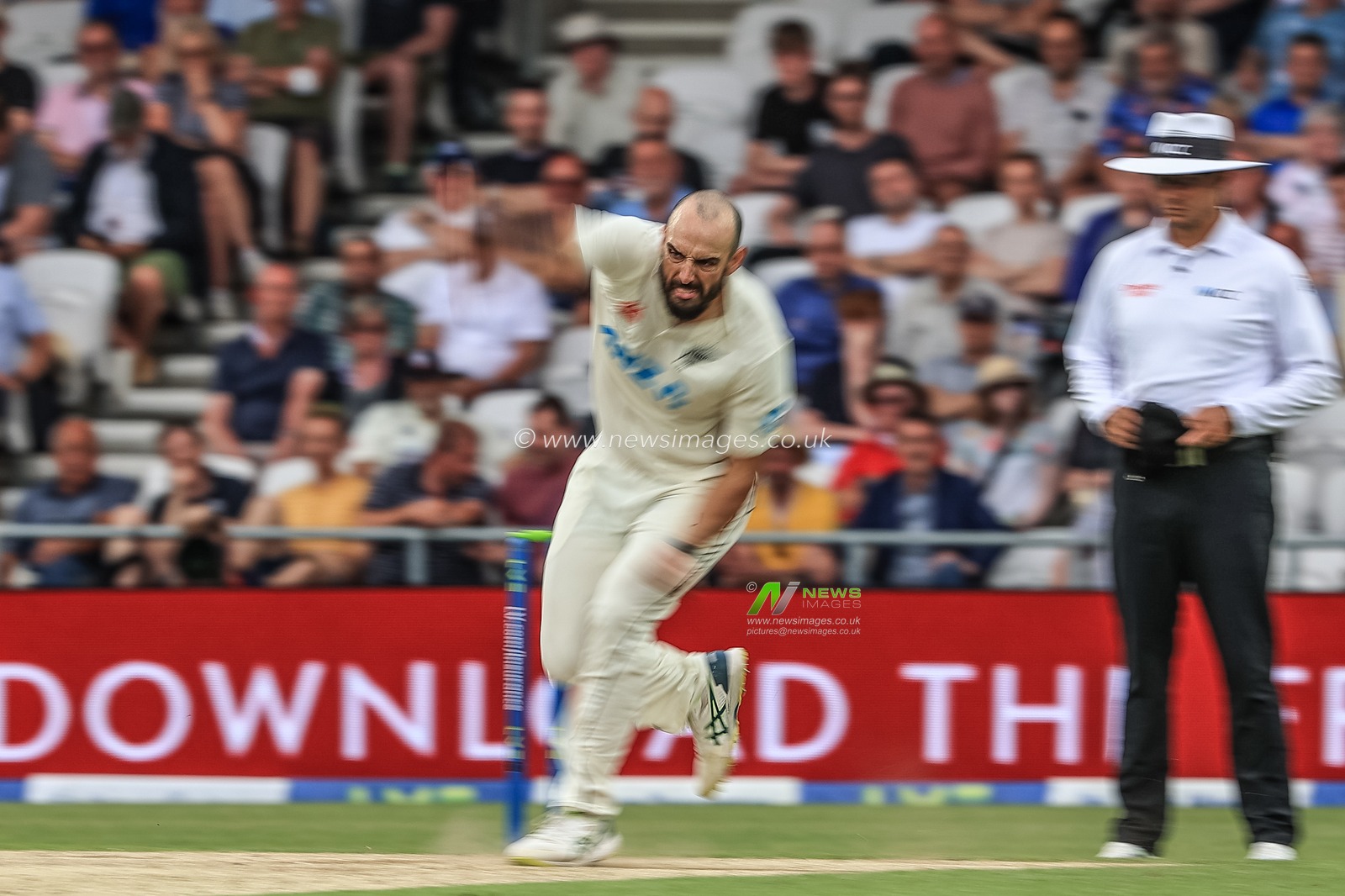 Daryl Mitchell of New Zealand delivers the ball