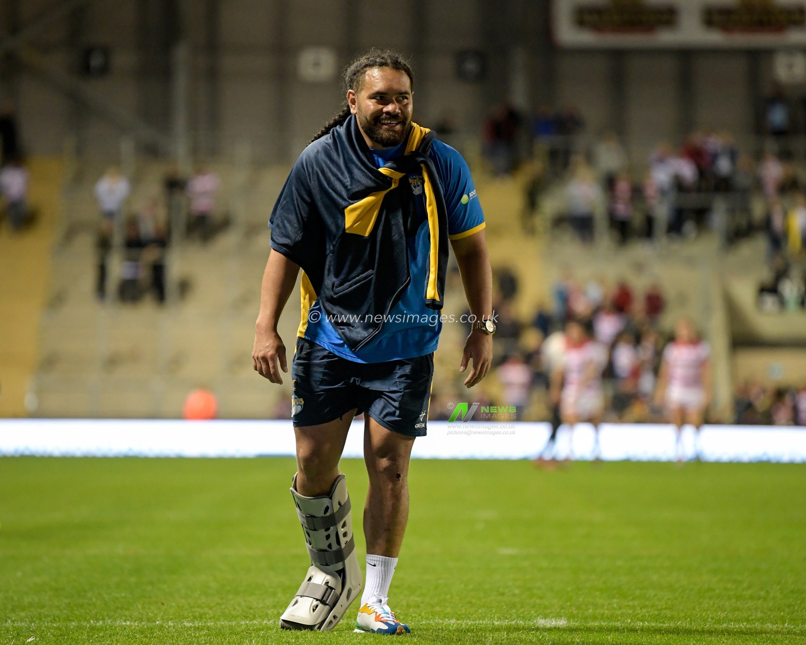 Konrad Hurrell (4) of Leeds Rhinos walks towards the travelling supporters while wearing a medical boot after the final whistle