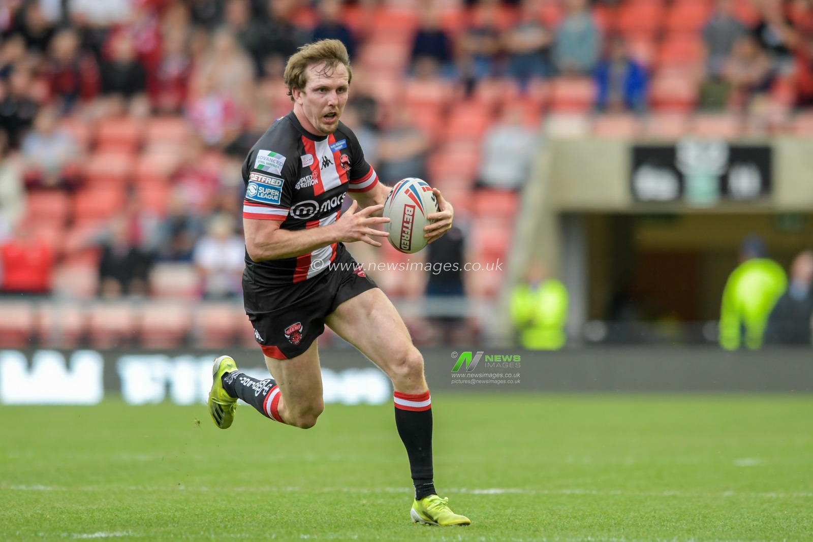 Dan Sarginson (23) of Salford Red Devils runs forward with the ball