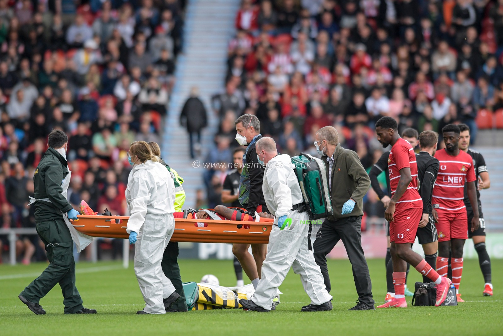A player listed as trialist 2 leaves the pitch on a stretcher