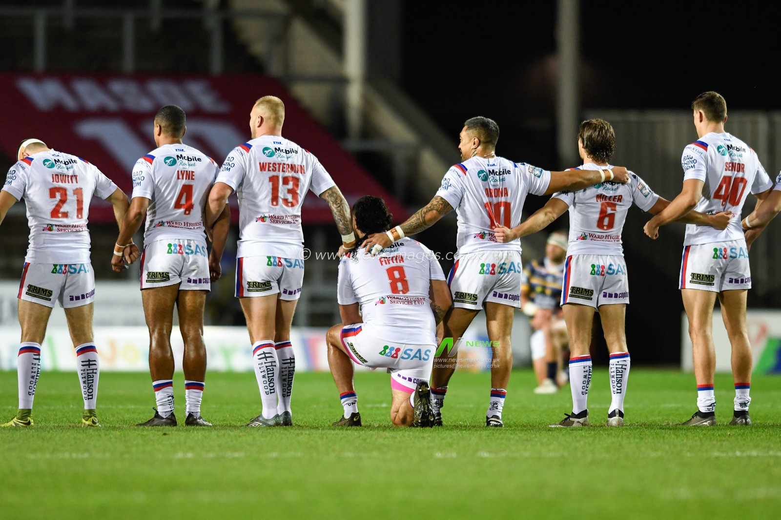 David Fifita (8) of Wakefield Trinity takes a knee while his team mates stand at the beginning of the game