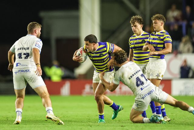 Josh Smith of Warrington Wolves is tackled by Louis Grossemey of Toulouse Olympique during the Betfred Super League round 27 match Warrington Wolves vs Toulouse Olympique at The Halliwell Jones Stadium, Warrington, United Kingdom on 11 September 2026

(Photo by Mark Cosgrove/News Images)