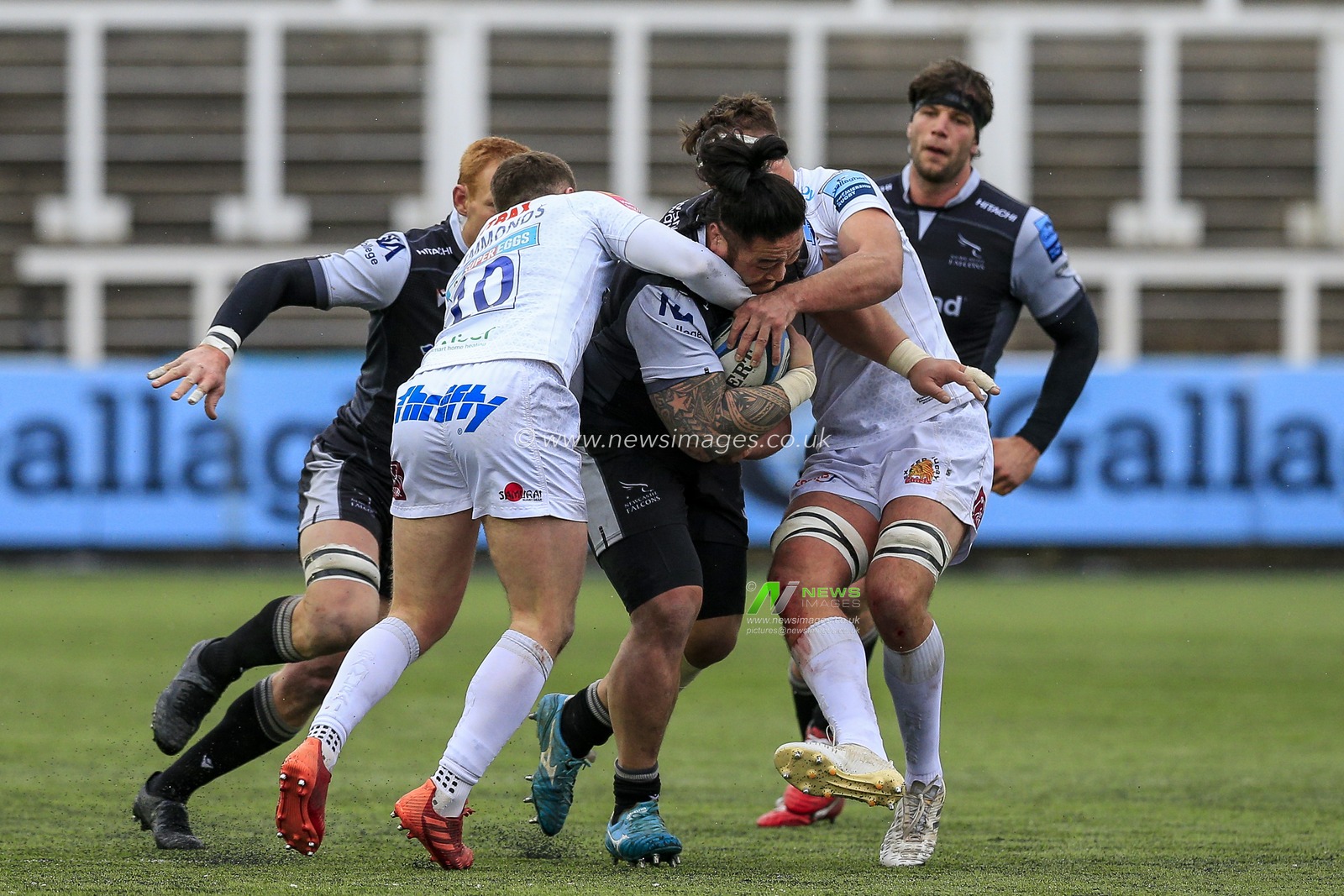 Logovi'i Mulipola of Newcastle Falcons is tackled by Joe Simmonds of Exeter Chiefs