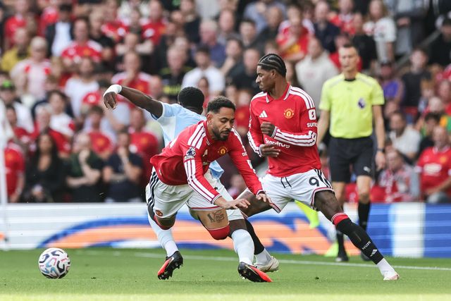 Matheus Cunha of Manchester United and Marc Guehi of Manchester City battle for the ball during the Premier League match Manchester United vs Manchester City at Old Trafford, Manchester, United Kingdom on 13 September 2026

(Photo by Mark Cosgrove/News Images)
