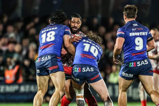 Isaac Liu of Leigh Leopards is tackled by Isaiah Vagana of Wakefield Trinity and Ky Rodwell of Wakefield Trinity during the Betfred Super League Play-off Eliminator round match Wakefield Trinity vs Leigh Leopards at DIY Kitchens Stadium, Wakefield, United Kingdom on 18 September 2026

(Photo by Alfie Cosgrove/News Images)