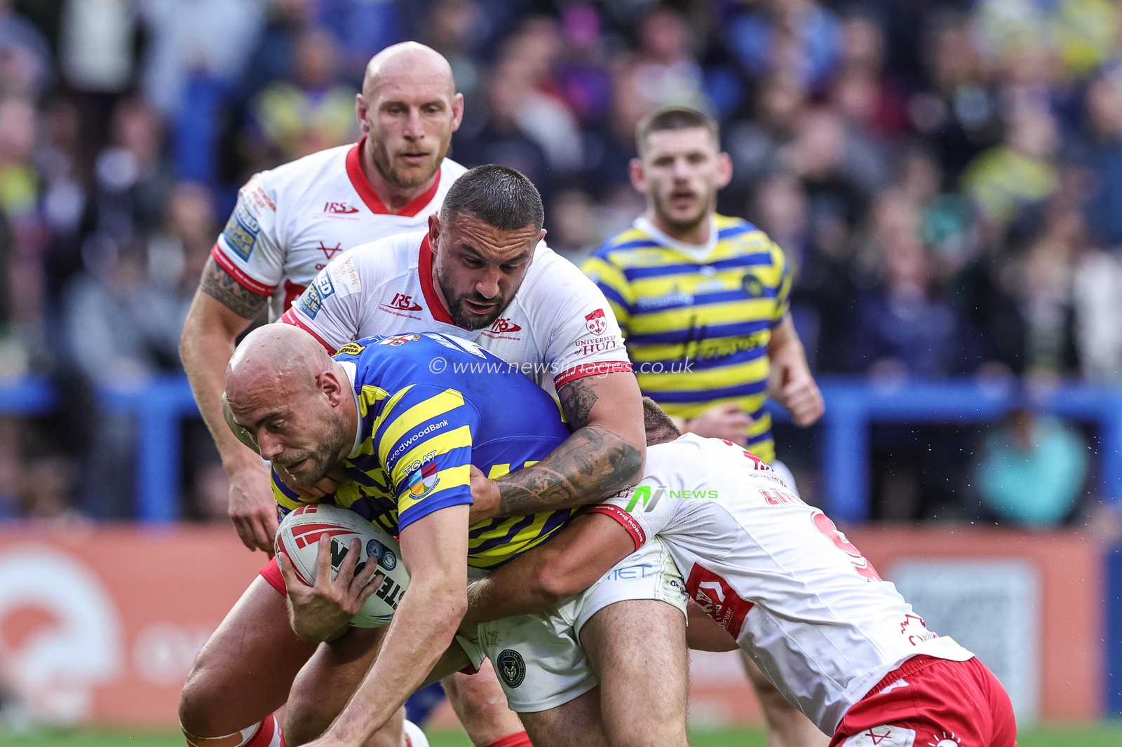 James Harrison of Warrington Wolves is tackled by Elliot Minchella of Hull KR and Jez Litten of Hull KR during the Betfred Super League Play-off Eliminator round match Warrington Wolves vs Hull KR at The Halliwell Jones Stadium, Warrington, United Kingdom on 19 September 2026

(Photo by Mark Cosgrove/News Images)