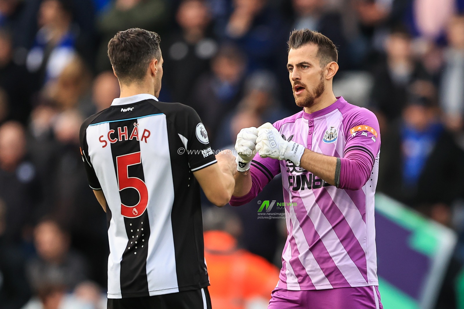 Martin Dubravka #1 and Fabian SchÃ¤r #5 of Newcastle United bump fists before the game