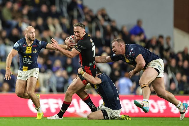 Ben Currie of Warrington Wolves is tackled by Cameron Smith of Leeds Rhinos during the Betfred Super League Play-off Semi-Final match Leeds Rhinos vs Warrington Wolves at AMT Headingley Stadium, Leeds, United Kingdom on 25 September 2026

(Photo by Mark Cosgrove/News Images)