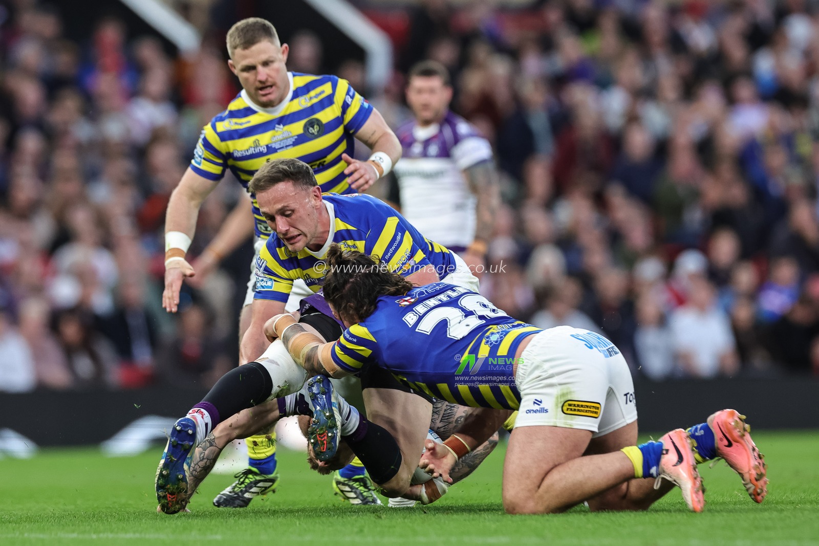 Tom Johnstone of Wakefield Trinity is tackled by James Bentley of Warrington Wolves and Ben Currie of Warrington Wolves  during the Betfred Super League Grand Final match Warrington Wolves vs Wakefield Trinity at Old Trafford, Manchester, United Kingdom on 03 October 2026

(Photo by Mark Cosgrove/News Images)