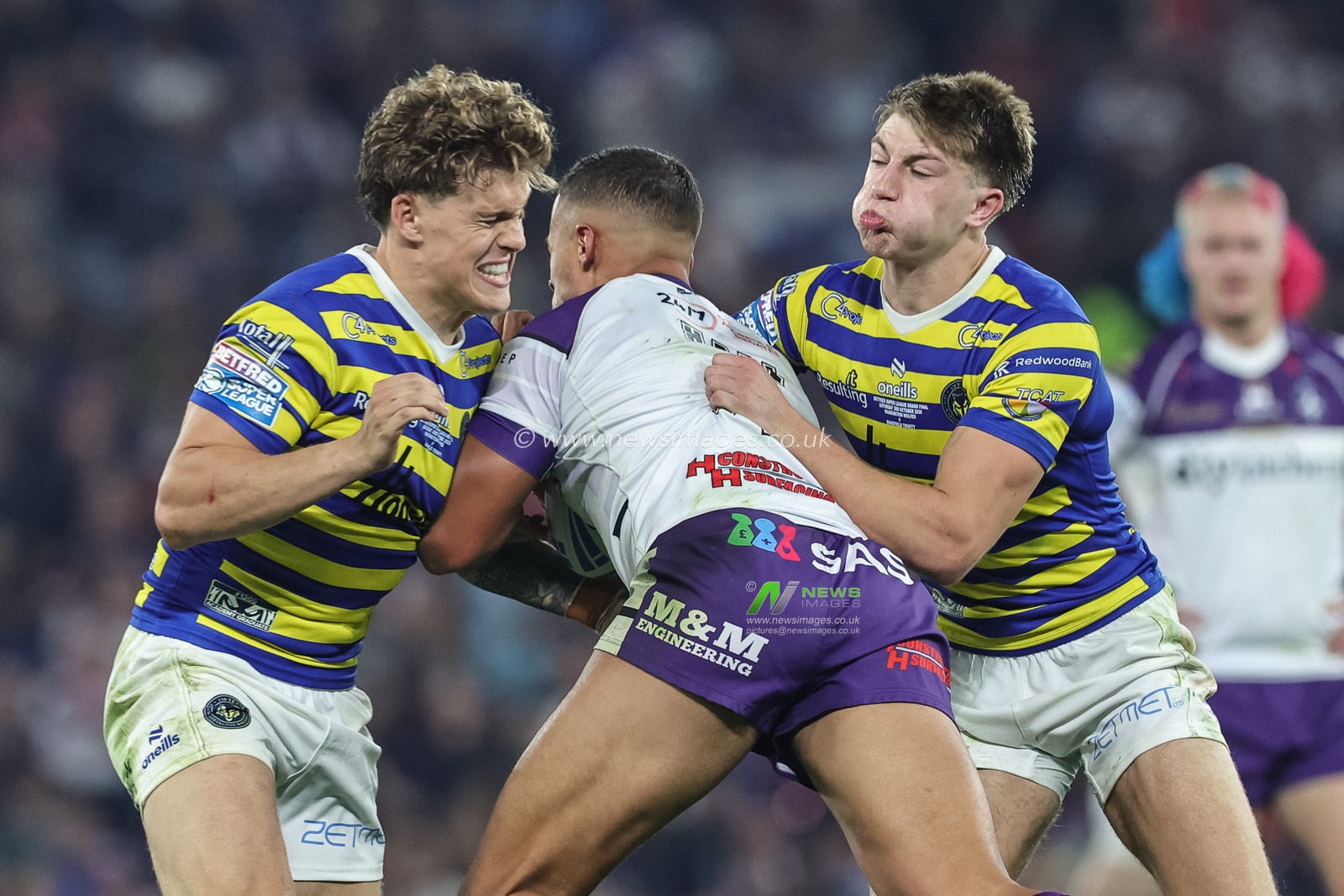 Corey Hall of Wakefield Trinity is tackled by Arron Lindop of Warrington Wolves and Ewan Irwin of Warrington Wolves during the Betfred Super League Grand Final match Warrington Wolves vs Wakefield Trinity at Old Trafford, Manchester, United Kingdom on 03 October 2026

(Photo by Mark Cosgrove/News Images)