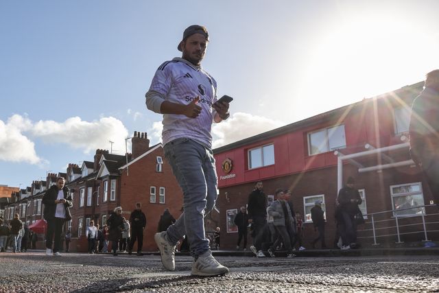 Manchester United fans make their way to Old Trafford during the Premier League match Manchester United vs Tottenham Hotspur at Old Trafford, Manchester, United Kingdom on 10 October 2026

(Photo by Mark Cosgrove/News Images)