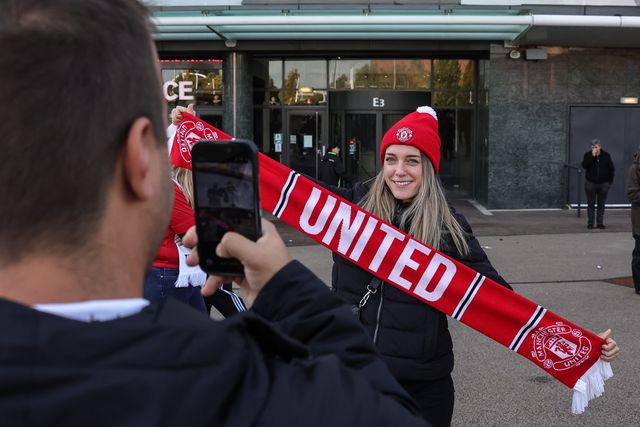 Manchester United fans pose for a selfie during the Premier League match Manchester United vs Tottenham Hotspur at Old Trafford, Manchester, United Kingdom on 10 October 2026

(Photo by Mark Cosgrove/News Images)