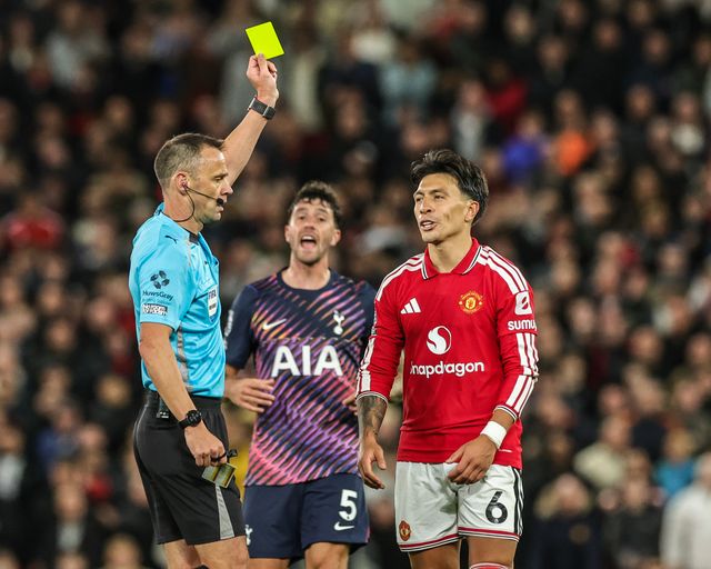 Referee Stuart Attwell gives a yellow card to Lisandro Martinez of Manchester United during the Premier League match Manchester United vs Tottenham Hotspur at Old Trafford, Manchester, United Kingdom on 10 October 2026

(Photo by Mark Cosgrove/News Images)
