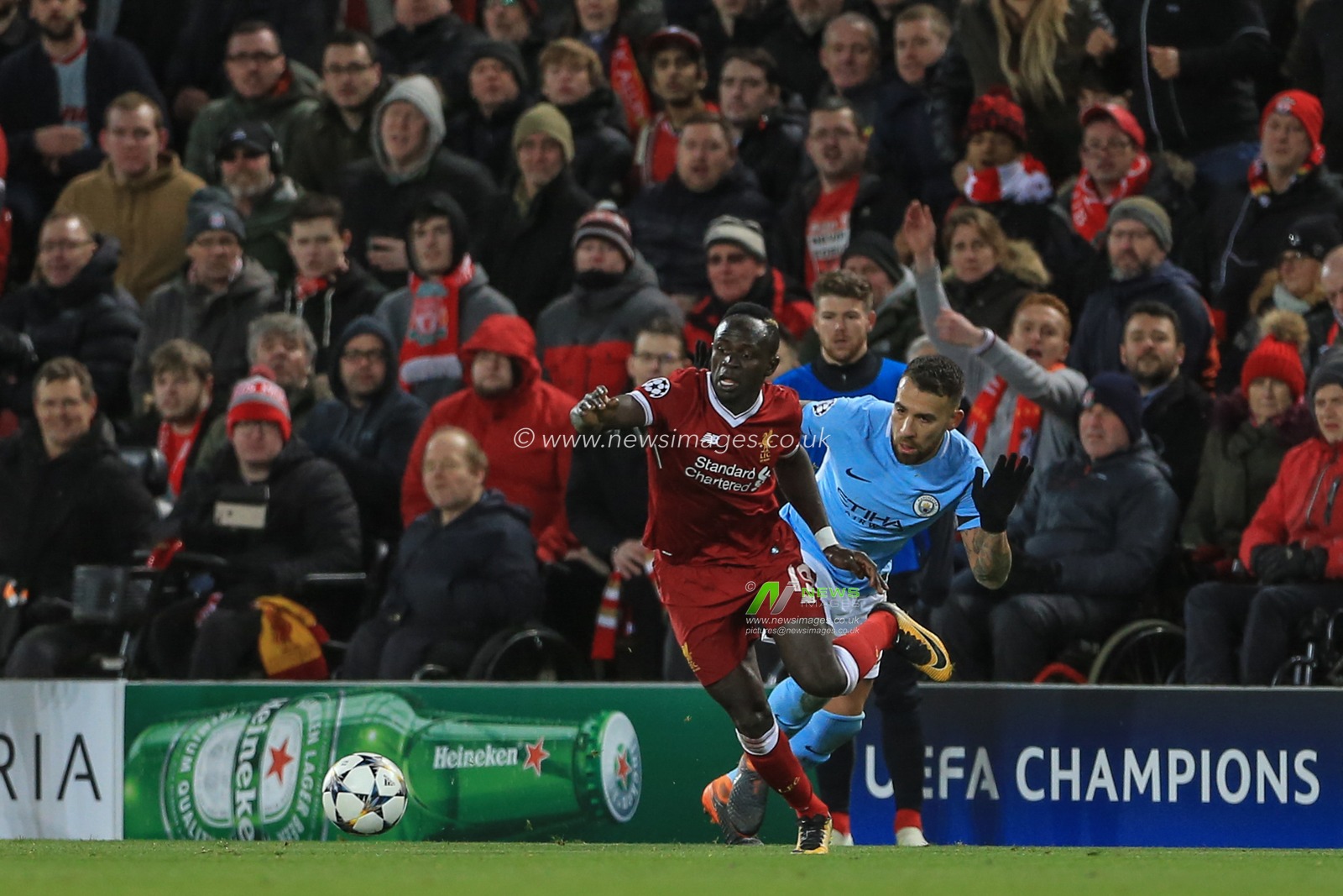 4th April 2018 , Anfield, Liverpool, England; Champions League Quarter Final, first leg, Liverpool v Manchester City; Sadio Mane of Liverpool passes the ball after holding odd Nicolas Otamendi of Manchester City
