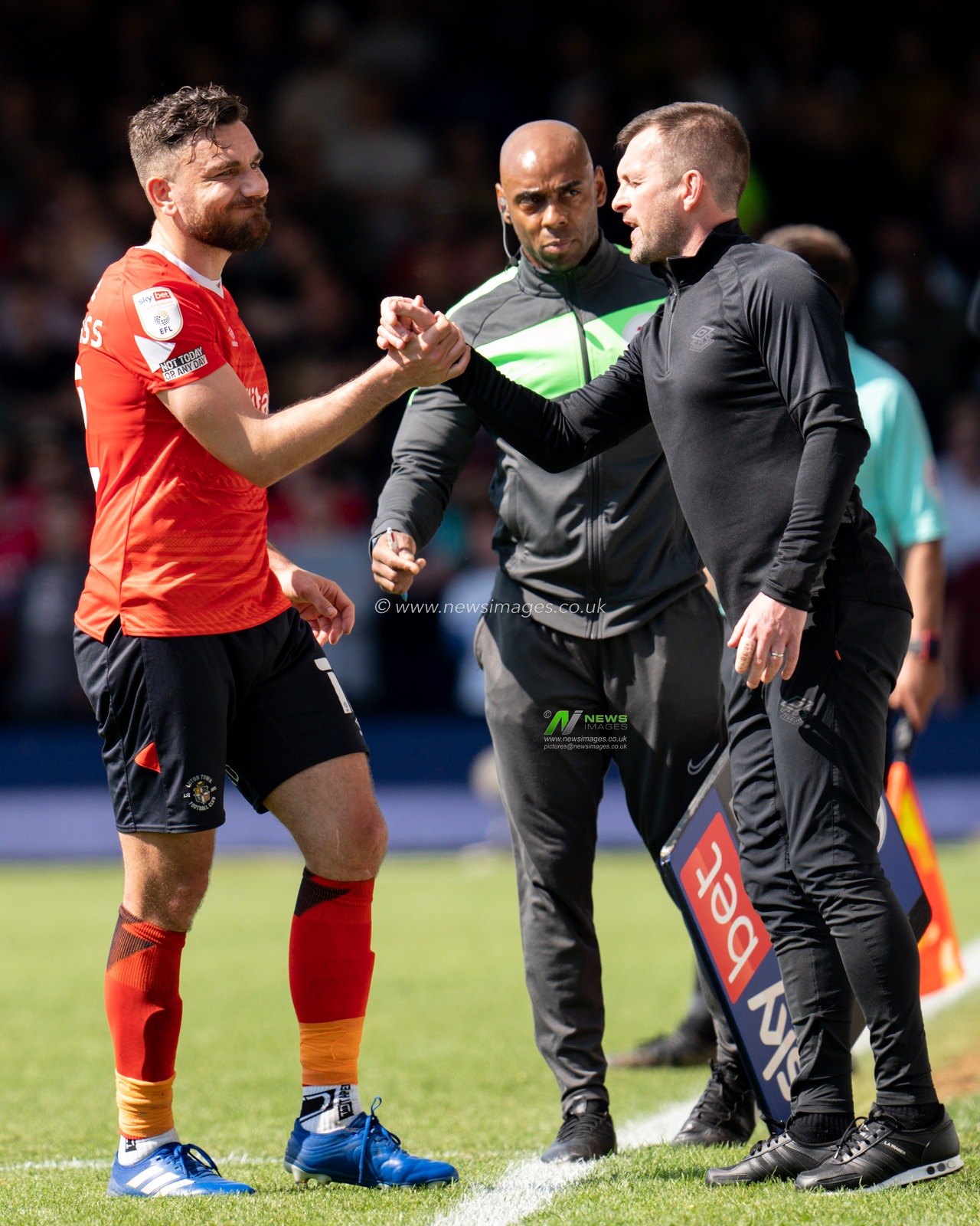 Robert Snodgrass #12 of Luton Town is substituted and Nathan Jones manager of Luton Town thanks him for his effort.