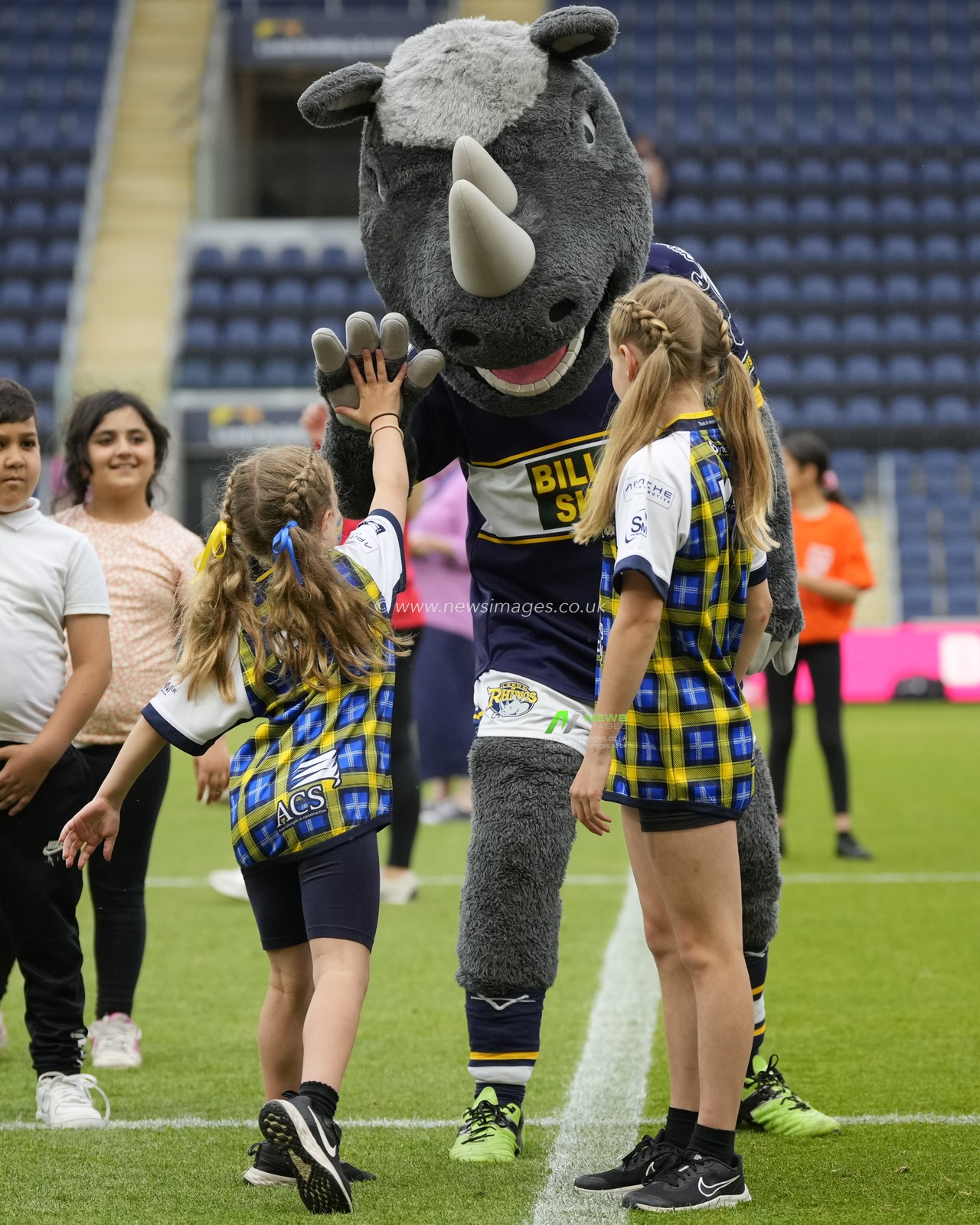 Rob Burrows Daughters Maya and Macy high five Ronnie the Rhino before leading 770 children in a dance before the Betfred Super League Round 16 match Leeds Rhinos vs Huddersfield Giants at Headingley Stadium, Leeds, United Kingdom, 23rd June 2023

(Photo by Steve Flynn/News Images)