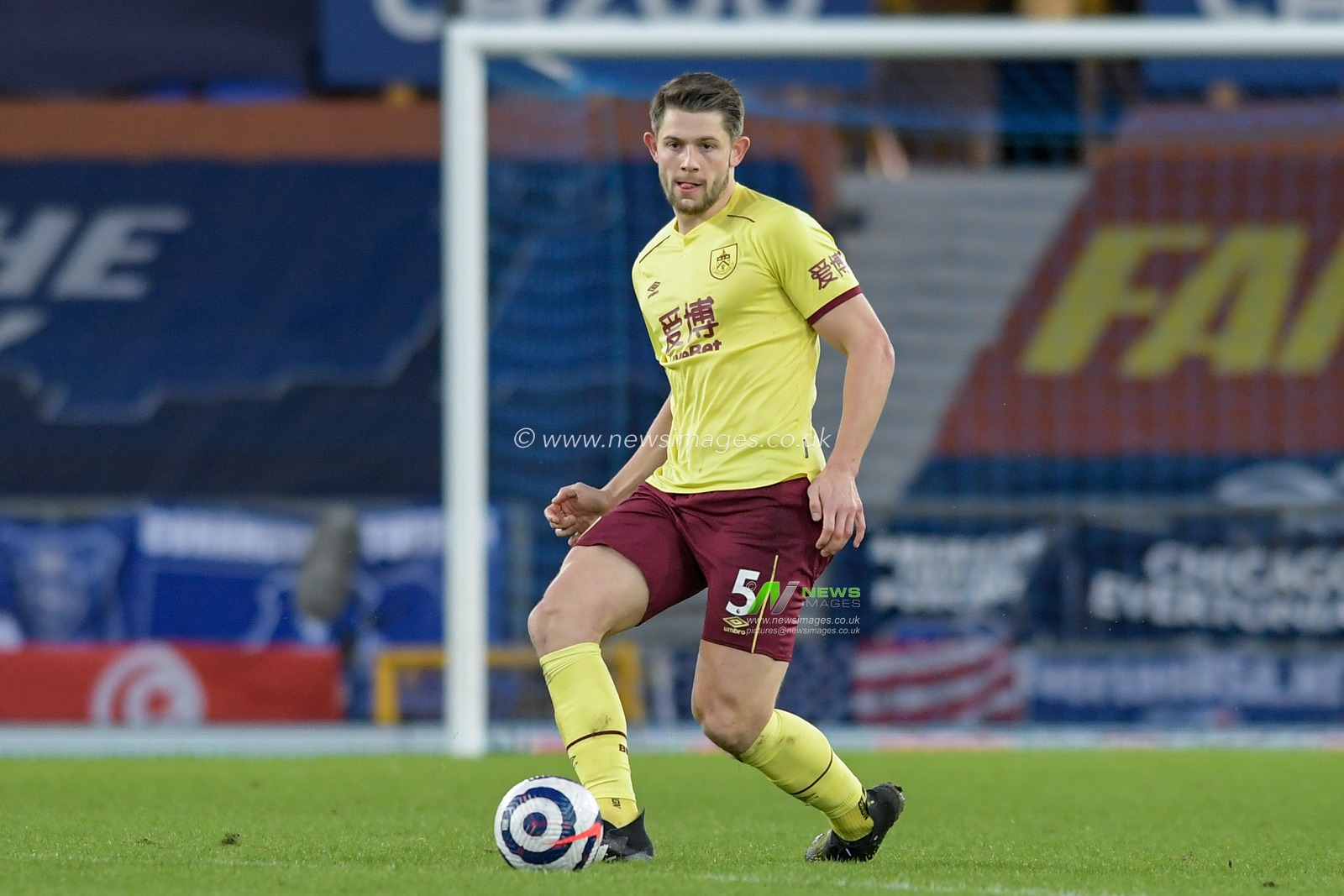 James Tarkowski #5 of Burnley passes the ball