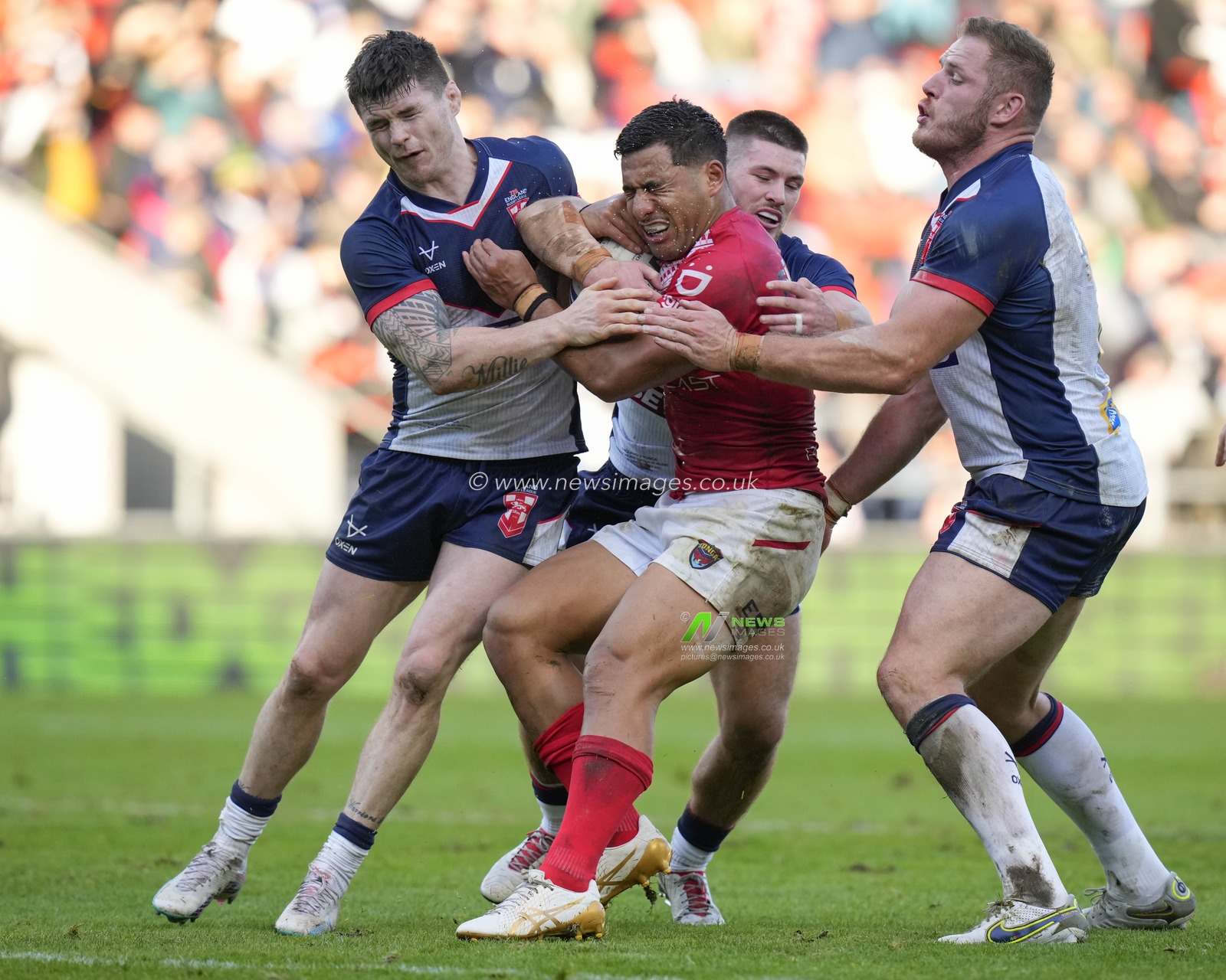 John Bateman #11 of England, Danny Walker #14 of England and Tom Burgess #8 of England put in a tackle during the Rugby League International match England vs Tonga at Totally Wicked Stadium, St Helens, United Kingdom, 22nd October 2023

(Photo by Steve Flynn/News Images)