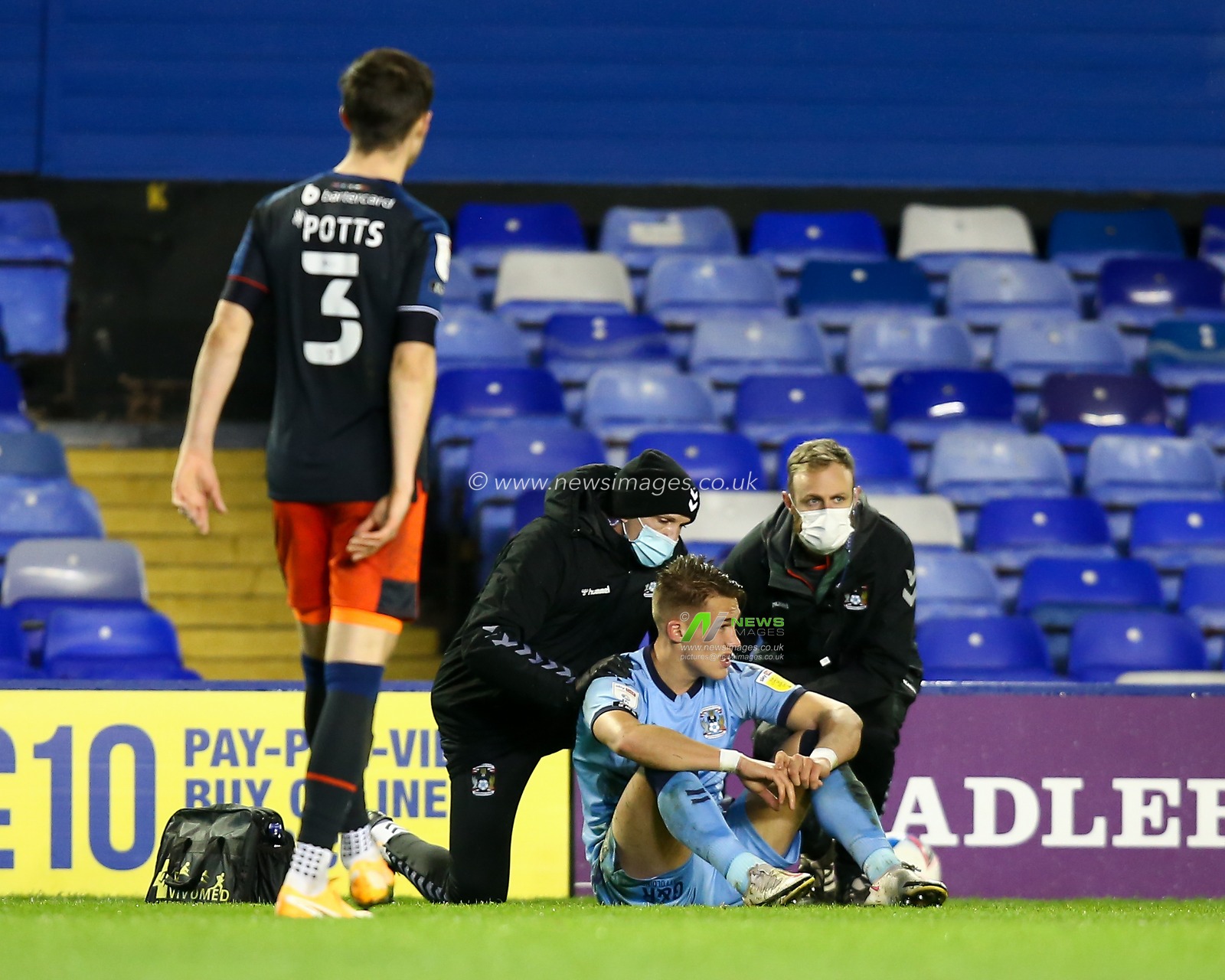 Leo Ostigard #2 of Coventry City requires attention from the physio after a bump on the head