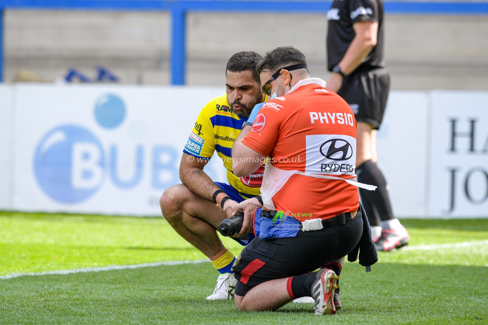 Greg Inglis (3) of Warrington Wolves is checked by the physio after picking up an injury