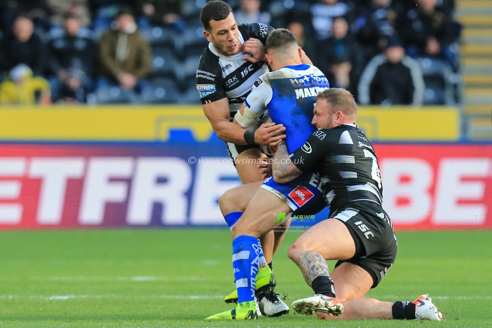 16th February 2020, KC Stadium, Hull, England; Betfred Super League, Hull FC v Saint Helens :Carlos Tuimavave (3) and Josh Griffin (4) of Hull FC tackle Tommy Makinson (2) of St Helens