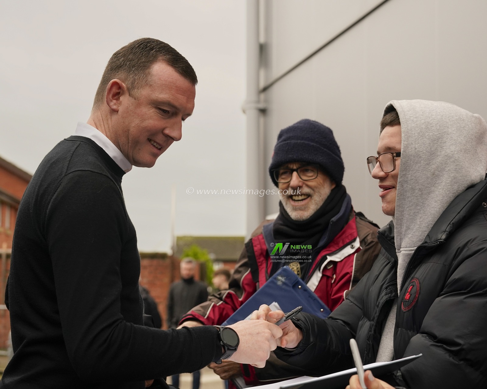 Neill Collins, manager of Barnsley signs an autograph for a fan as he arrives at the stadium before the Sky Bet League 1 match Fleetwood Town vs Barnsley at Highbury Stadium, Fleetwood, United Kingdom, 17th February 2024

(Photo by Steve Flynn/News Images)