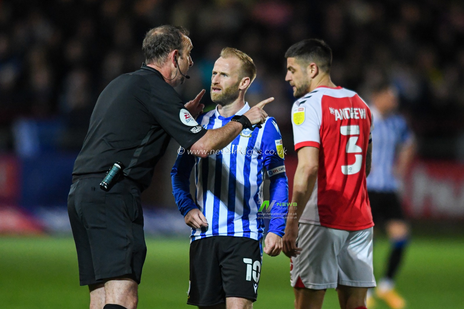Referee Carl Boyeson speaks to Barry Bannan #10 of Sheffield Wednesday during the game