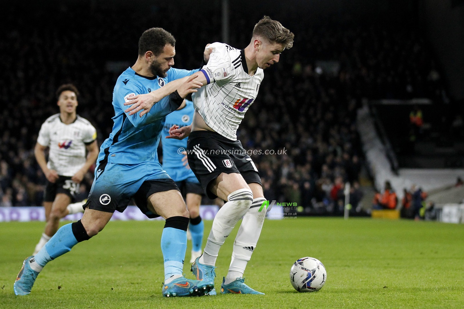 Tom Cairney #10 of Fulham and Mason Bennett #20 of Millwall.
