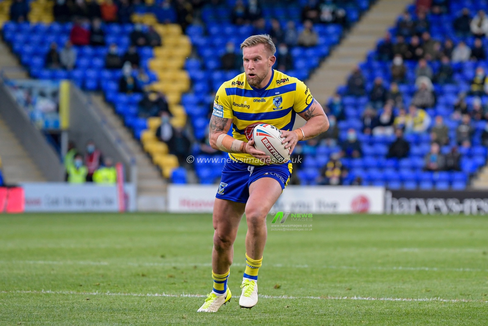 Mike Cooper (10) of Warrington Wolves runs forward with the ball