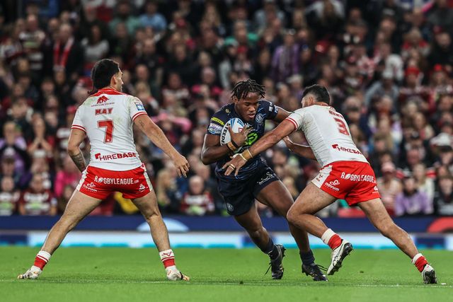 Junior Nsemba of Wigan Warriors evades a tackle form Peta Hiku of Hull KR during the 2025 Betfred Super League Grand Final Hull KR v Wigan Warriors at Old Trafford, Manchester, United Kingdom, 11th October 2025

(Photo by Alfie Cosgrove/News Images)