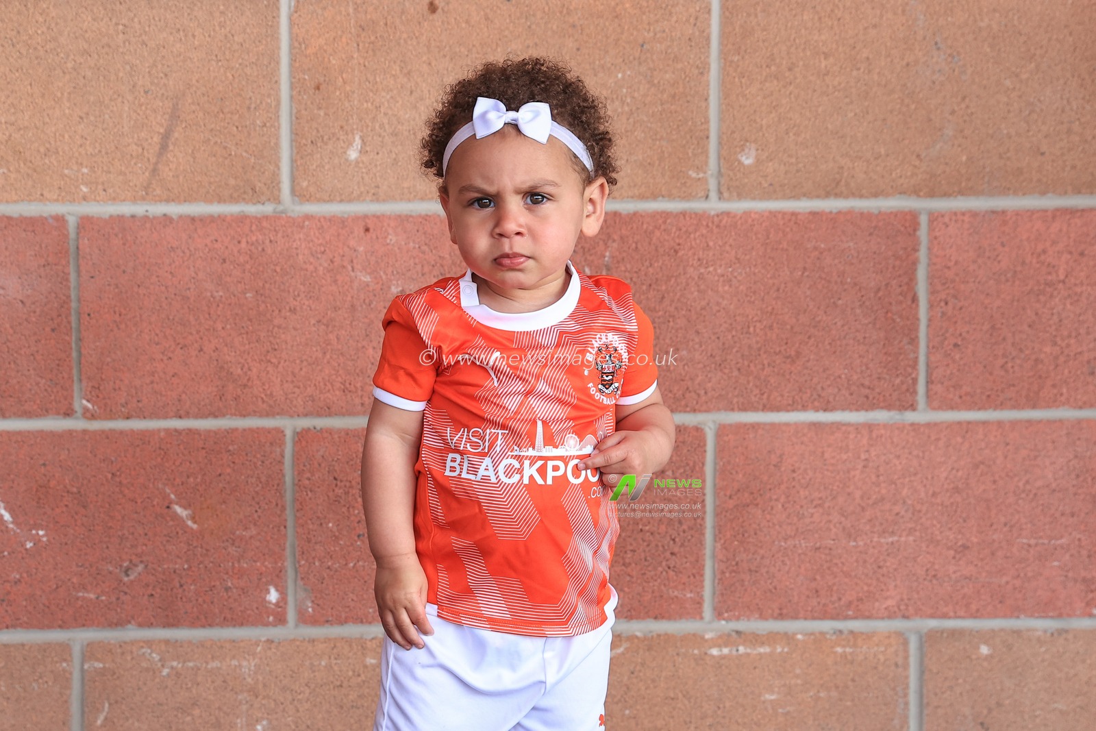 A young Blackpoll fan wearing a full home kit