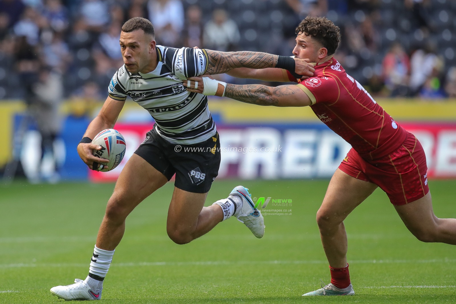 Carlos Tuimavave #3 of Hull FC is tackled by Arthur Romano #19 of Catalans Dragons during the Betfred Super League Round 17 Hull FC vs Catalans Dragons at MKM Stadium, Hull, United Kingdom, 1st July 2023

(Photo by James Heaton/News Images)