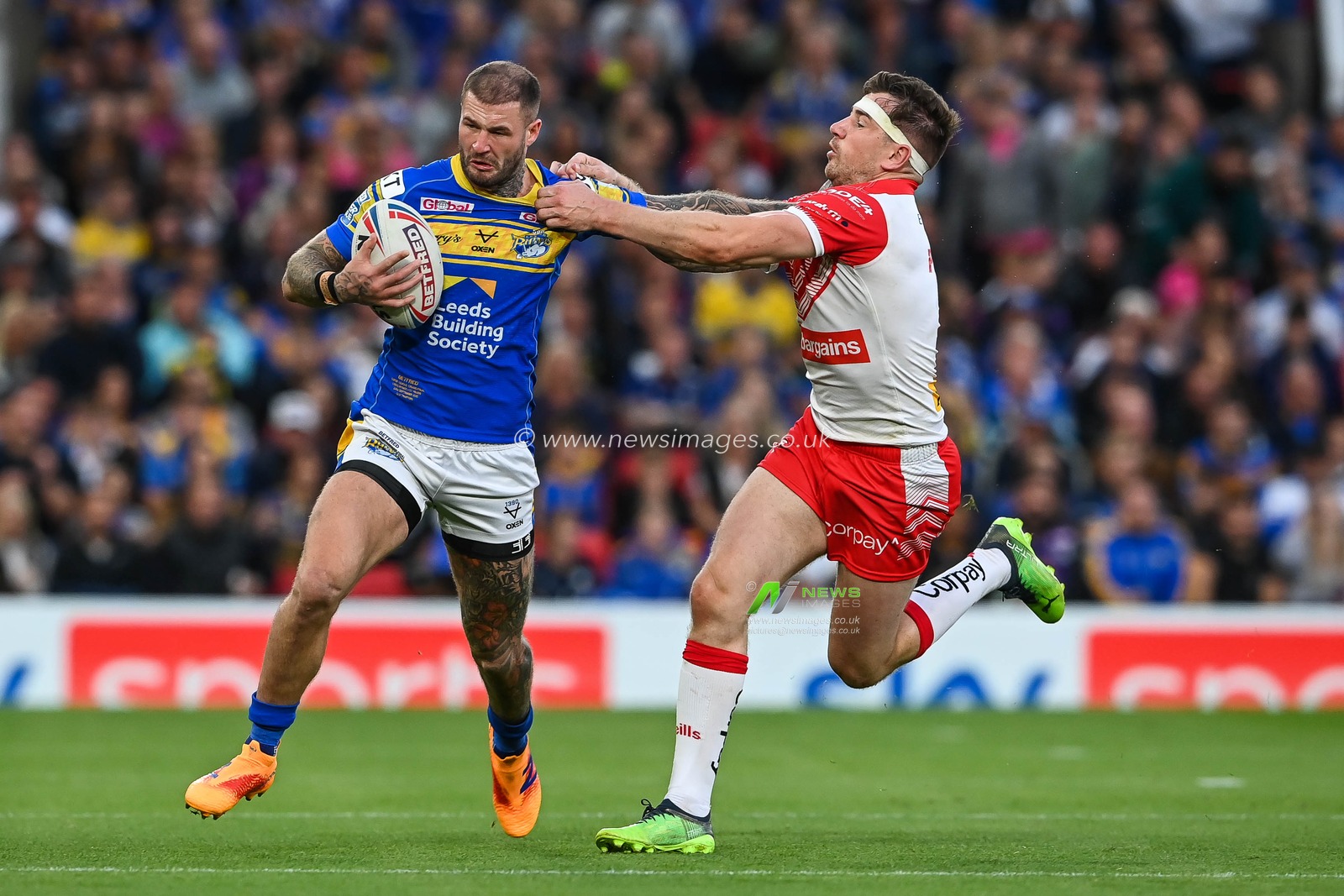 Zak Hardaker #33 of Leeds Rhinos fends off Mark Percival #4 of St Helens during the 25th Betfred Super League Grand Final match St Helens vs Leeds Rhinos at Old Trafford, Manchester, United Kingdom, 24th September 2022

(Photo by Craig Thomas/News Images)