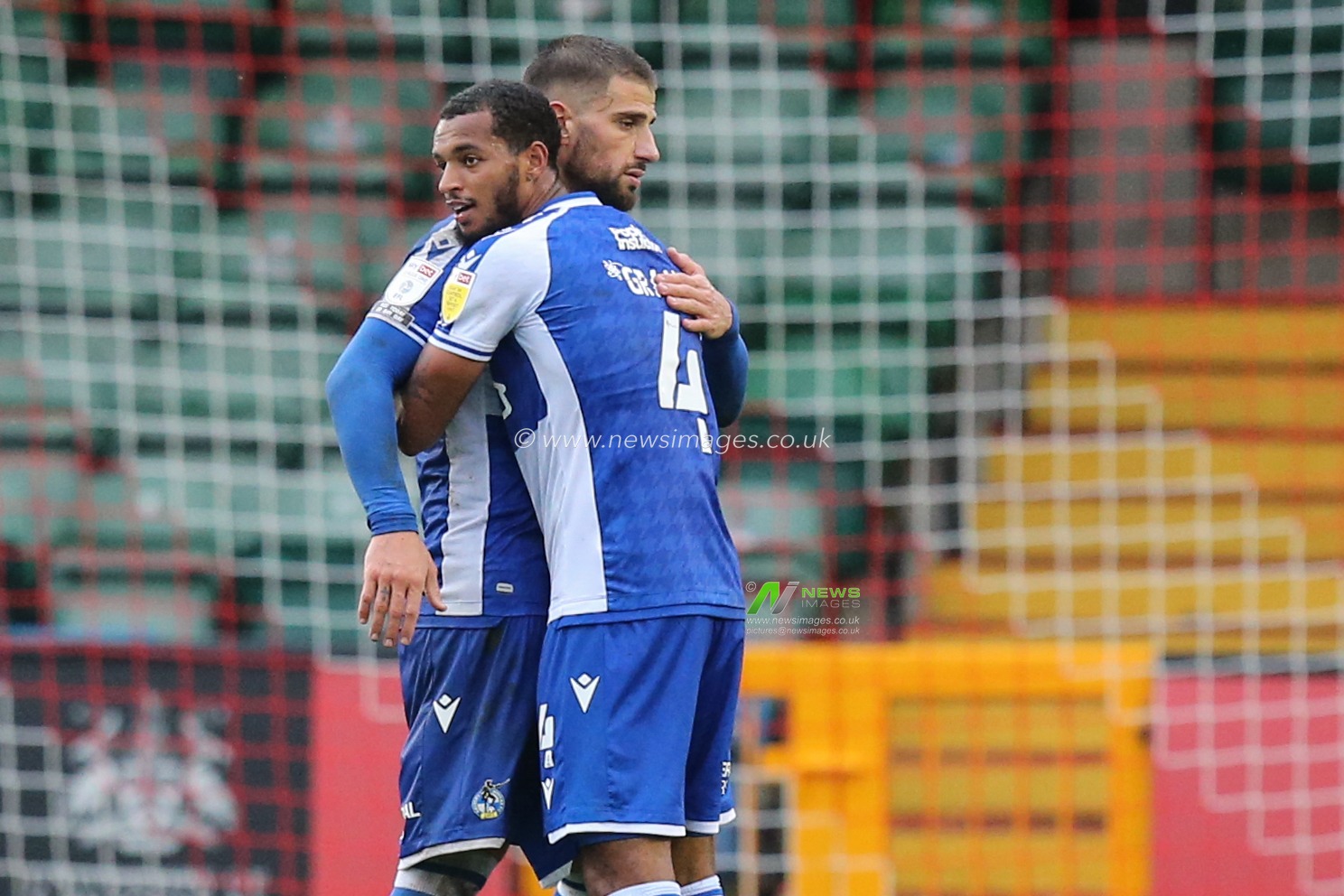 Bristol Rovers players congratulate each other after the final whistle