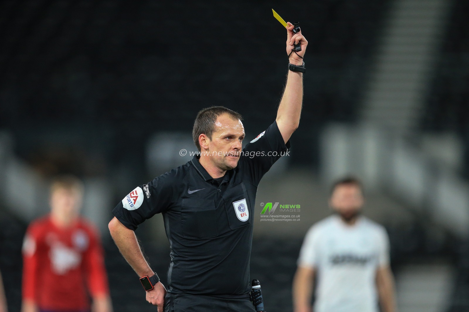 referee Geoff Eltringham gives Jaden Brown #28 of Huddersfield Town a second yellow card followed by a red and sends him off