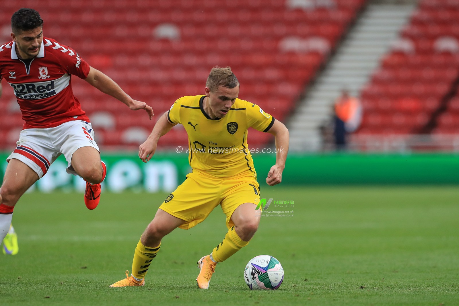 Luke Thomas (16) of Barnsley holds the ball as Sam Morsy (5) of Middlesbrough pressures