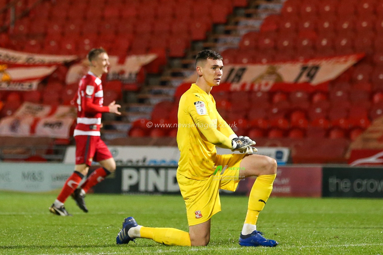 MatÄ›j KovaÅ™ #1 of Swindon Town reacts to Reece James #3 of Doncaster Rovers goal to make it 1-0