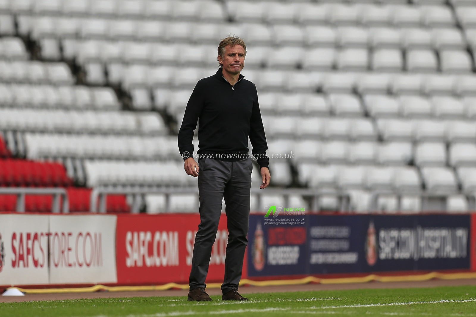 Phil Parkinson, manager of Sunderland, looks on as his side attack