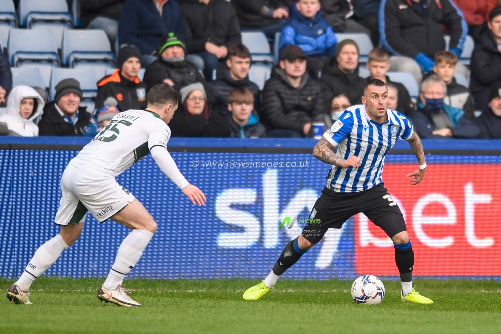 Jack Hunt #32 of Sheffield Wednesday looks for a way past Conor Grant #15 of Plymouth Argyle