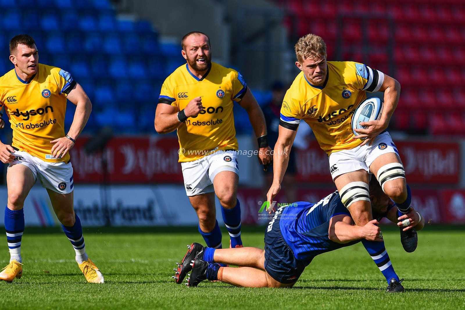 Tom Ellis of Bath is tackled by WillGriff John of Sale Sharks