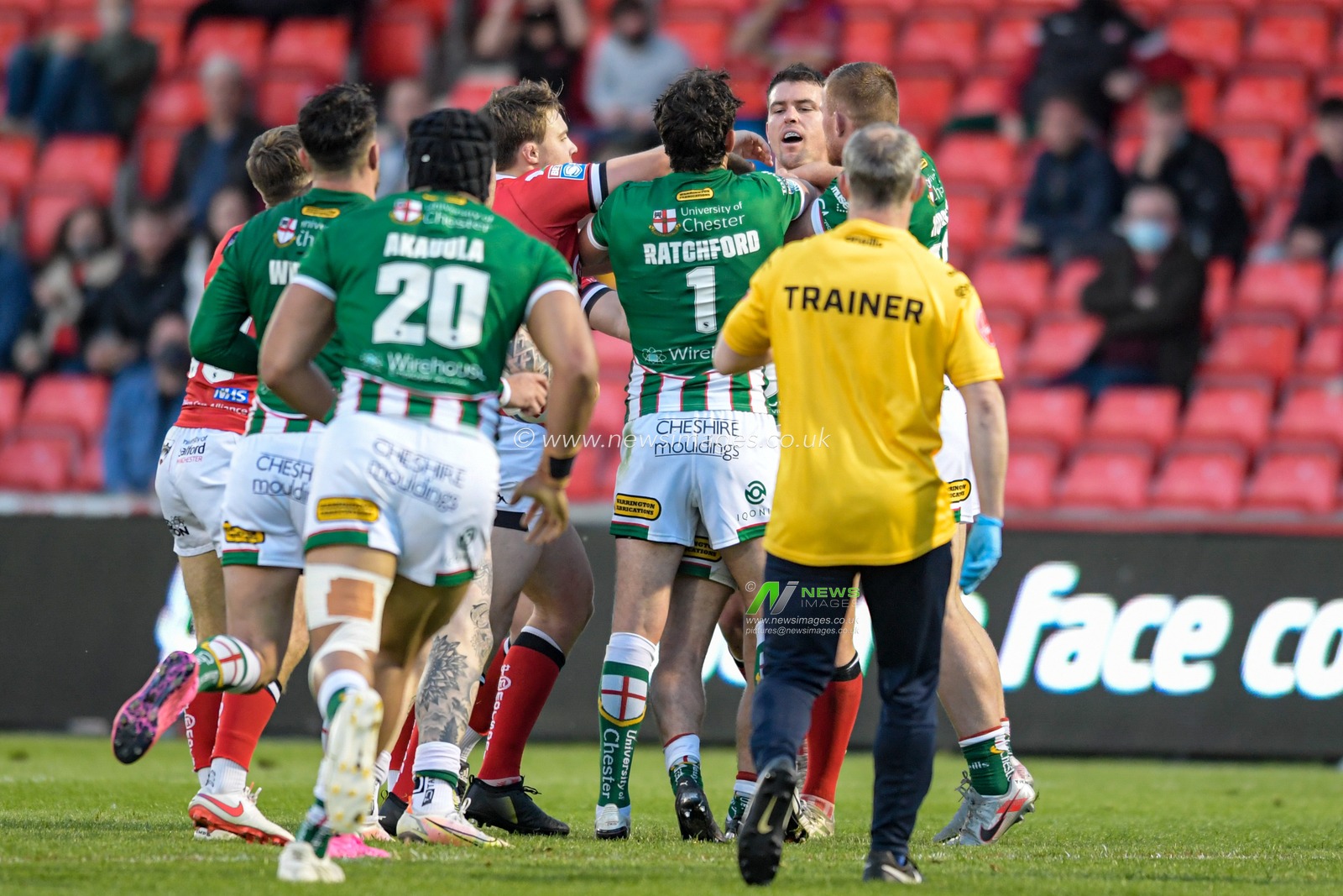 Players from both teams have an altercation on the pitch