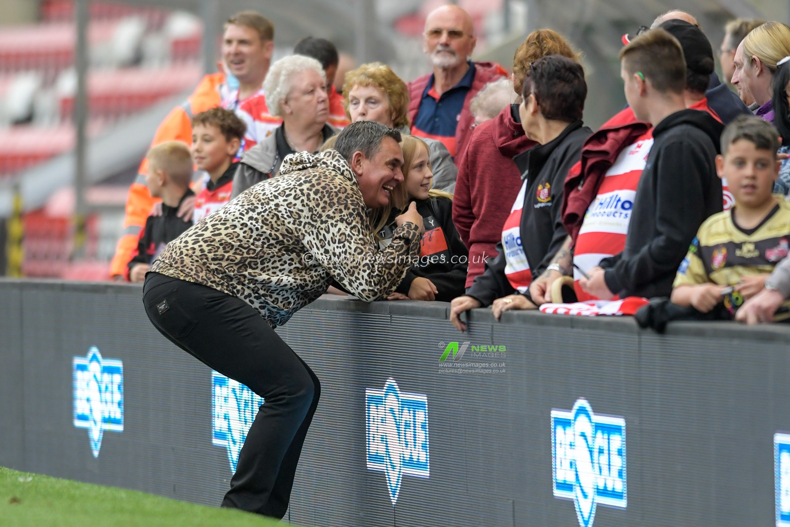 Derek Beaumont owner of Leigh Centurions poses for photographs with the home supporters after seeing his team win for the first time this season