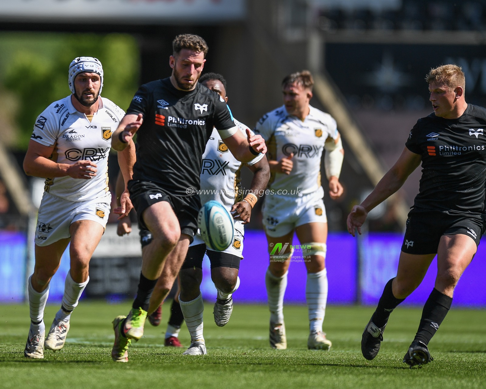 Alex Cuthbert of Ospreys, kicks the loose ball on the attack